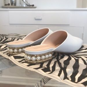 White pearl and silver heel slides.